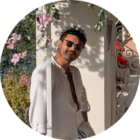 a man wearing glasses and a hat